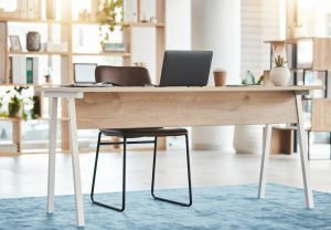 Interior design, furniture and laptop in workspace, room and desk for professional aesthetic, produ