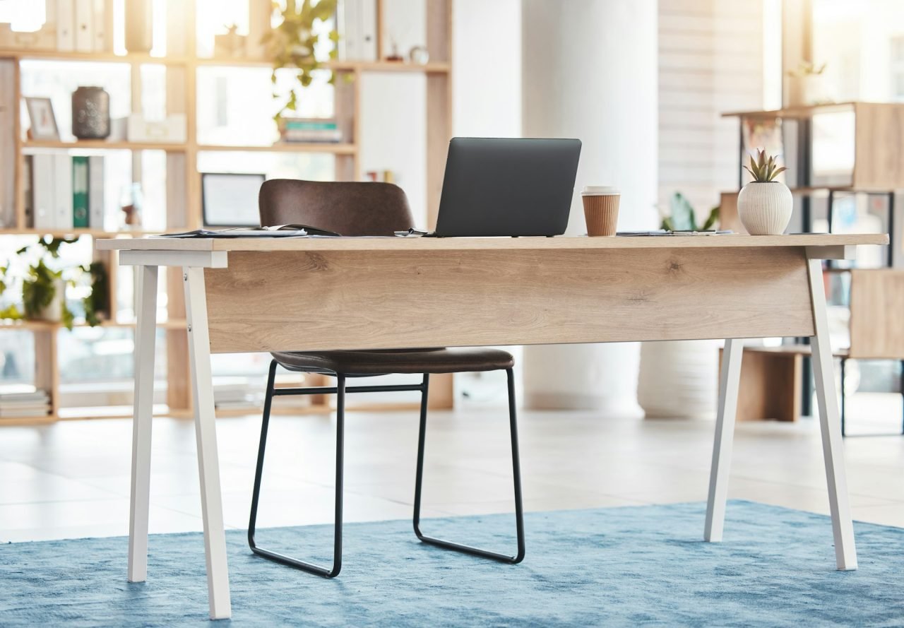 Interior design, furniture and laptop in workspace, room and desk for professional aesthetic, produ