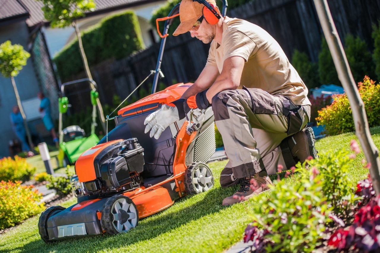Professional Landscape Gardener Getting Ready to Mow the Lawn