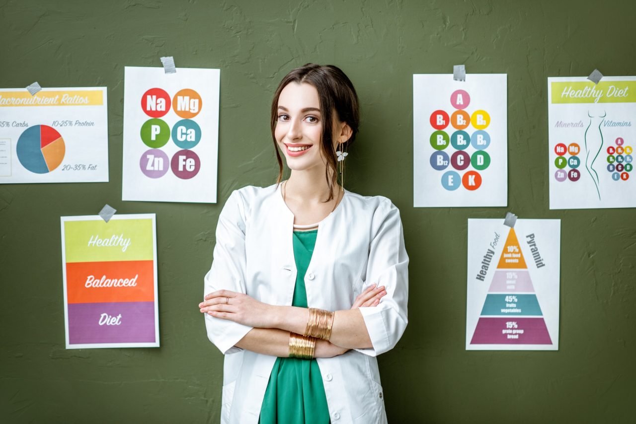 Portrait of a woman dietitian with schemes on the topic of nutrition