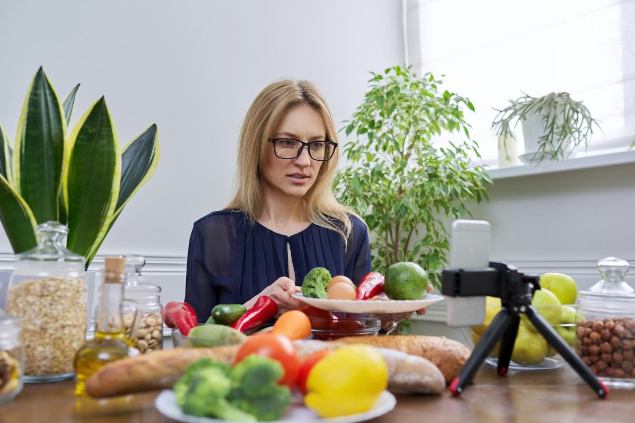 Woman nutritionist recording a video about healthy food, nutrition