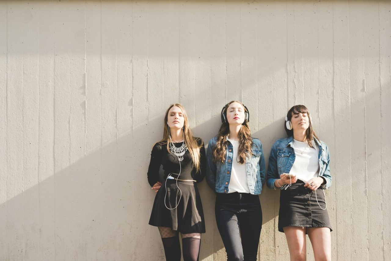Three women listening music