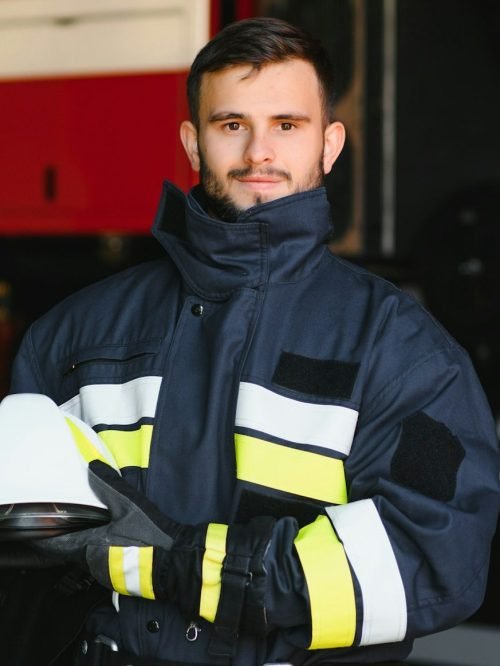 Photo of fireman with gas mask and helmet near fire engine