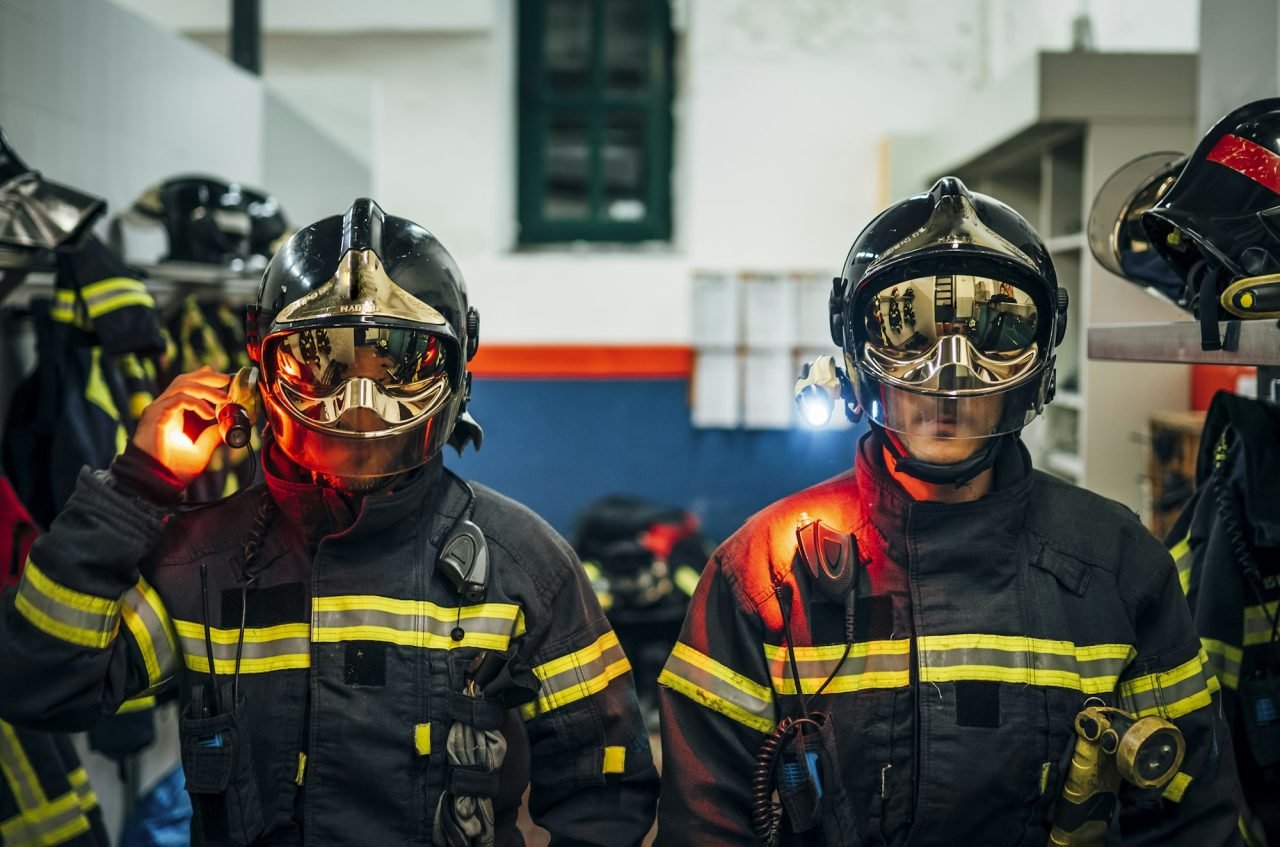Two male firefighter posing to camera.