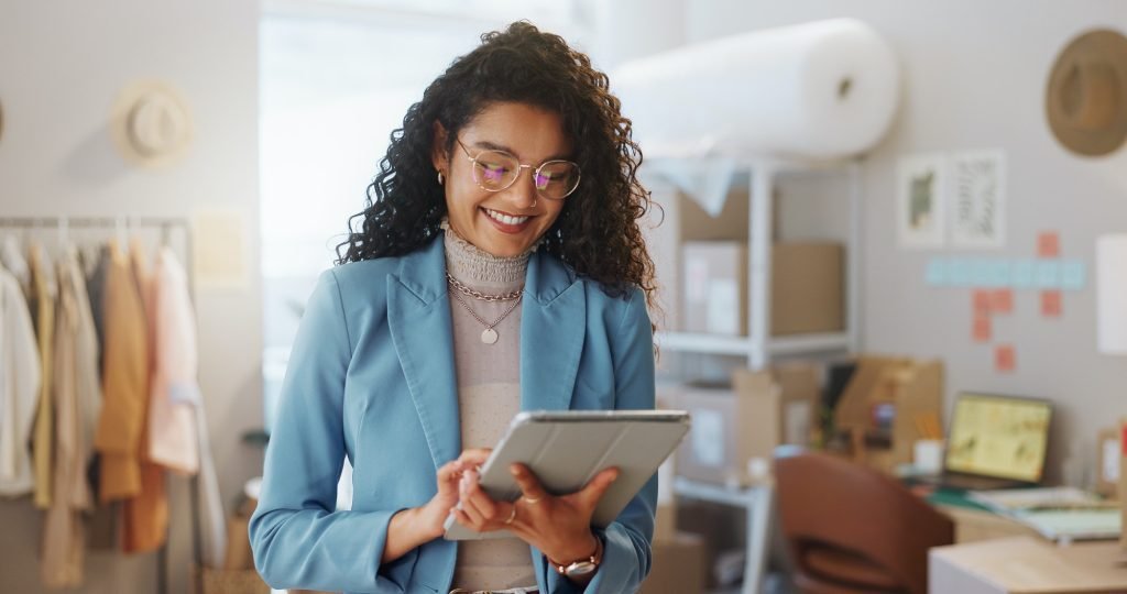 Ecommerce, boxes and woman with a tablet, business and smile with connection, internet and delivery