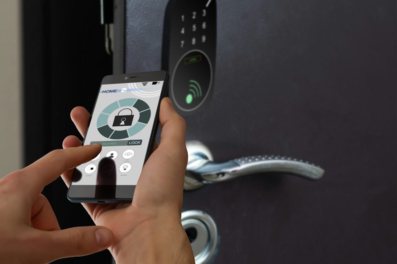 smart house, home automation, device with app icons. Man uses his smartphone with smarthome security