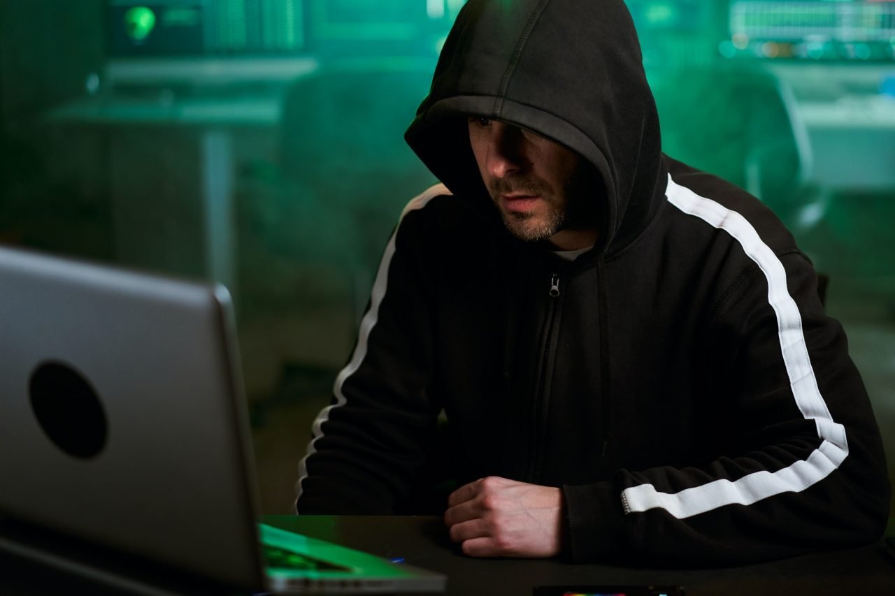 Computer hacker typing code on keyboard late night working and bypassing cyber security.