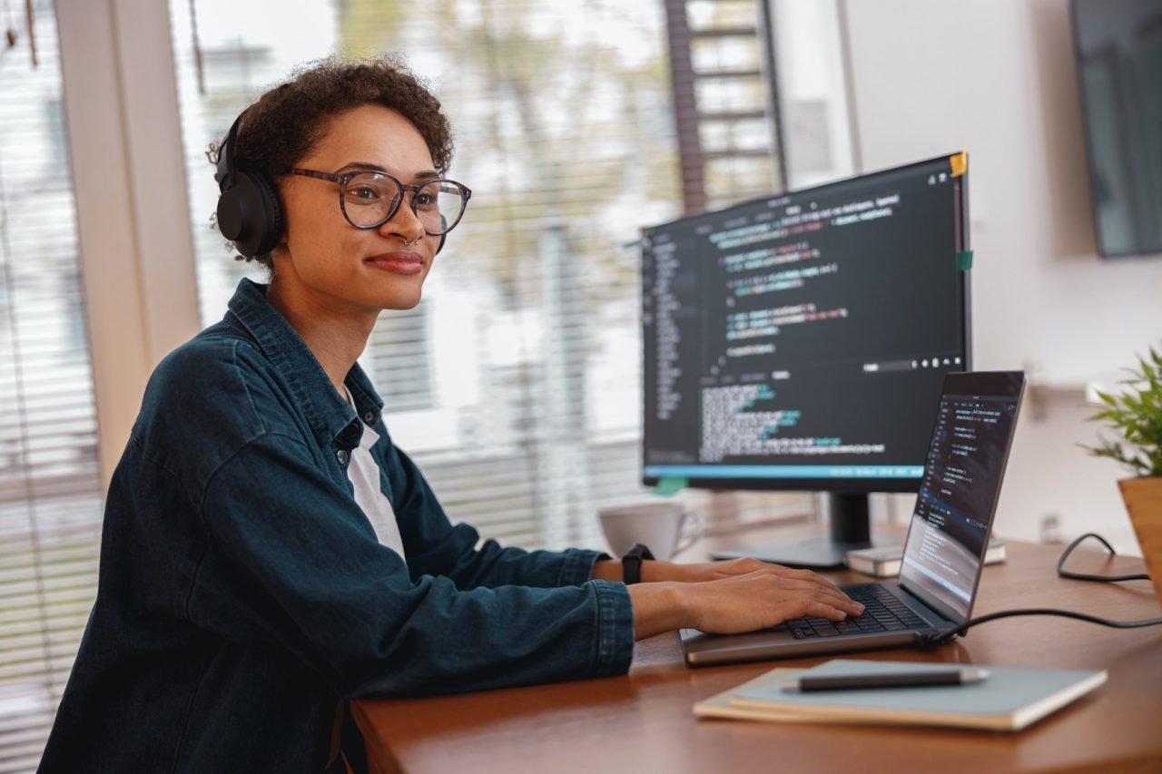 Female freelancer making new project as web designer and programmer on her computer at home
