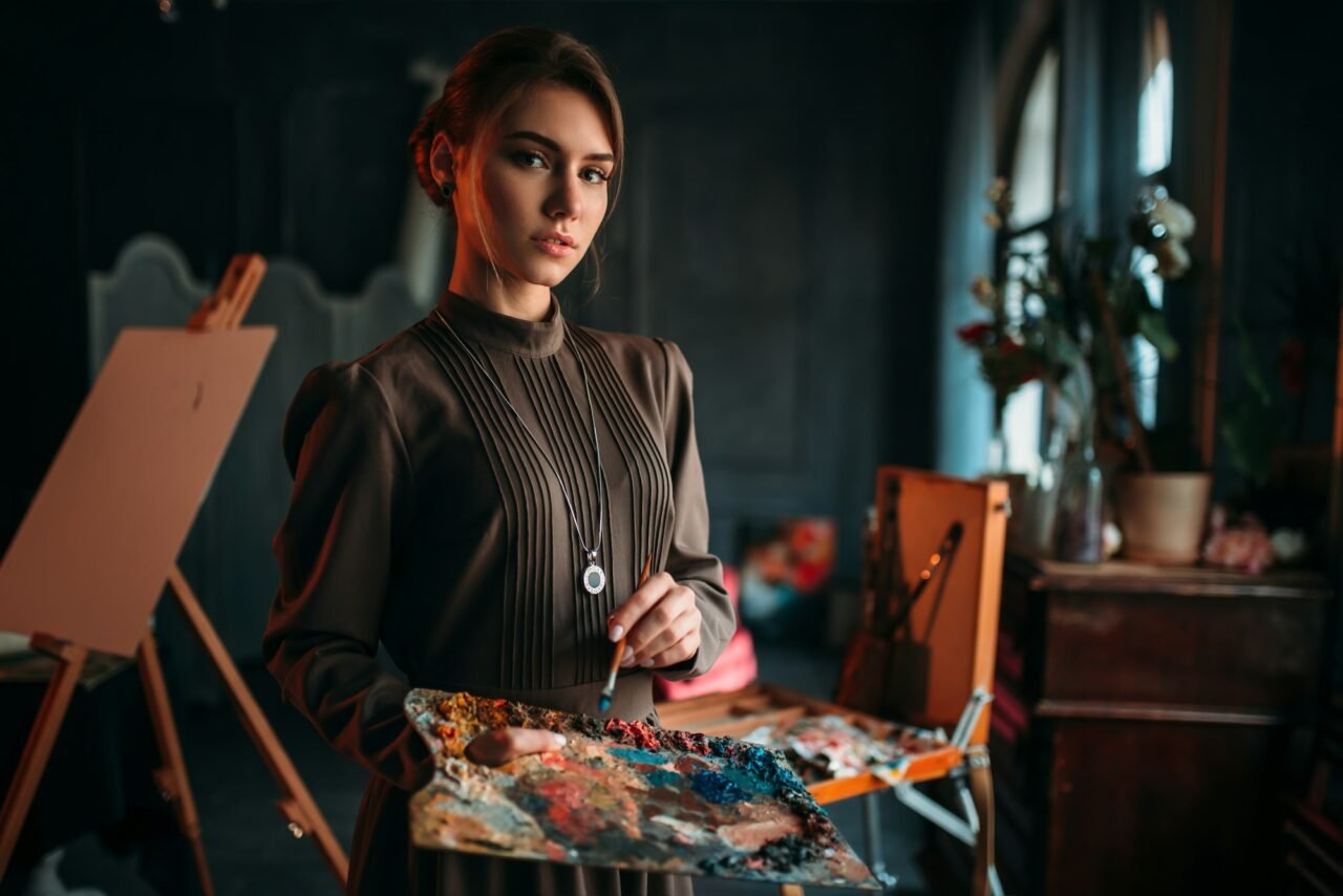 Female painter with brush and palette in hands