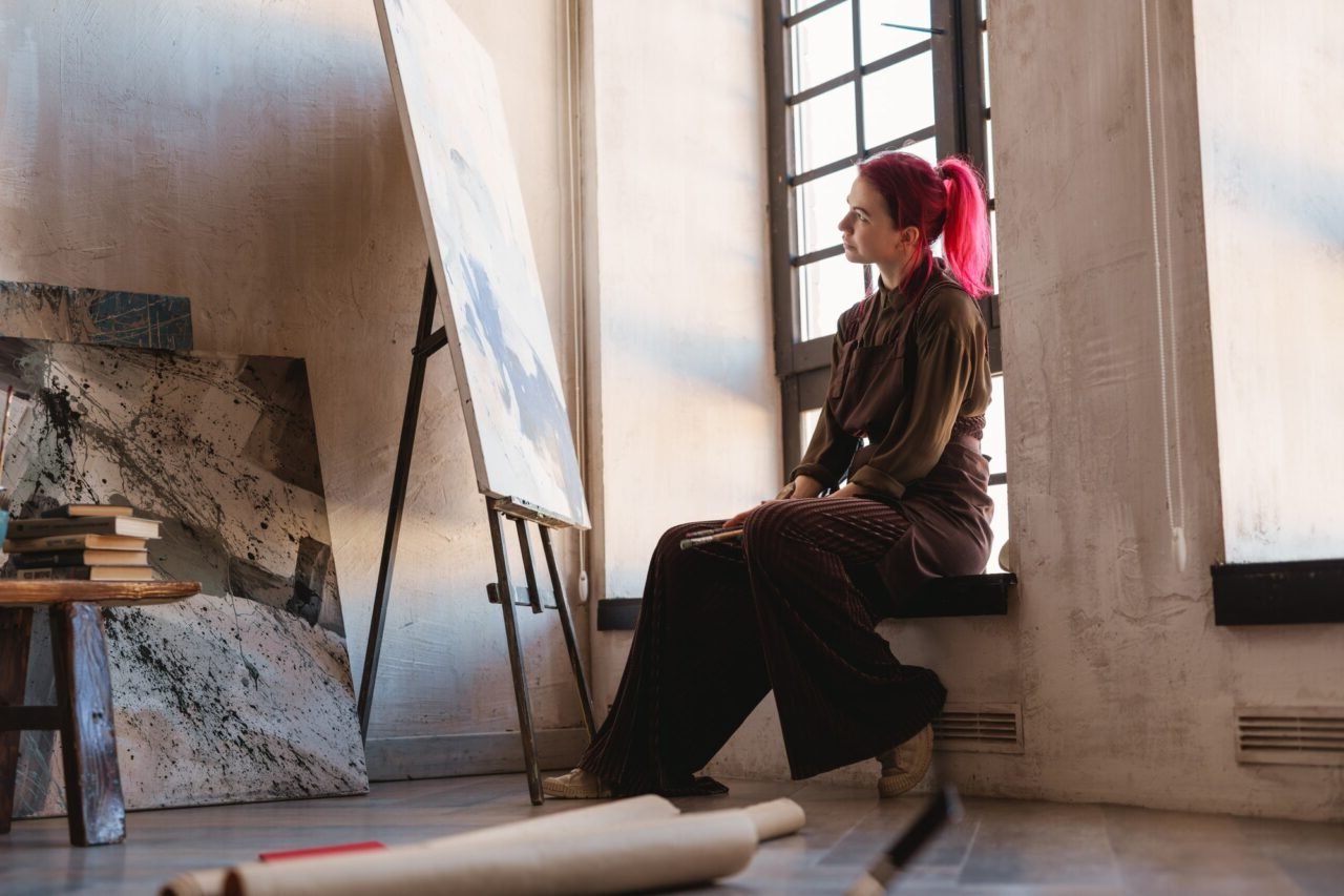 Young white woman painter in an art studio