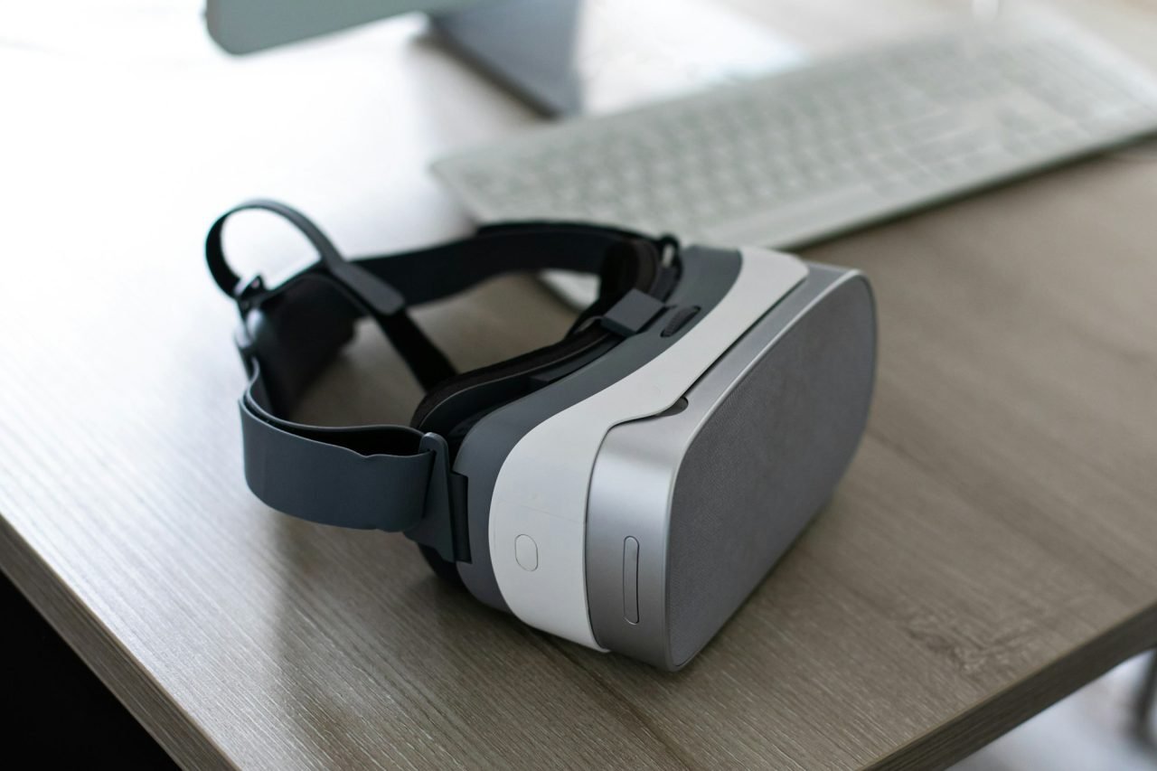 Black VR glasses mask on wooden table. Virtual reality headset