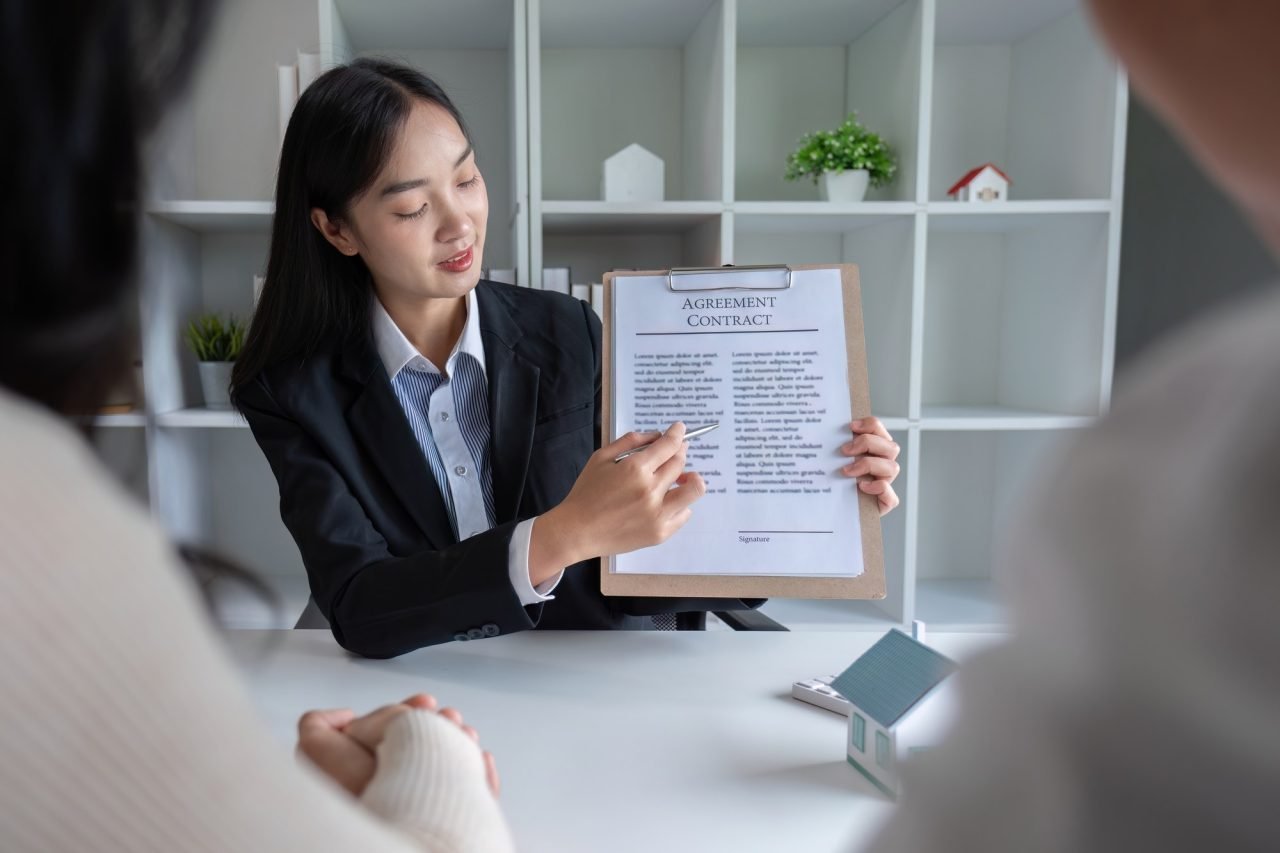 The real estate agent makes an offer to get the couple to sign a contract to buy the house. Happy