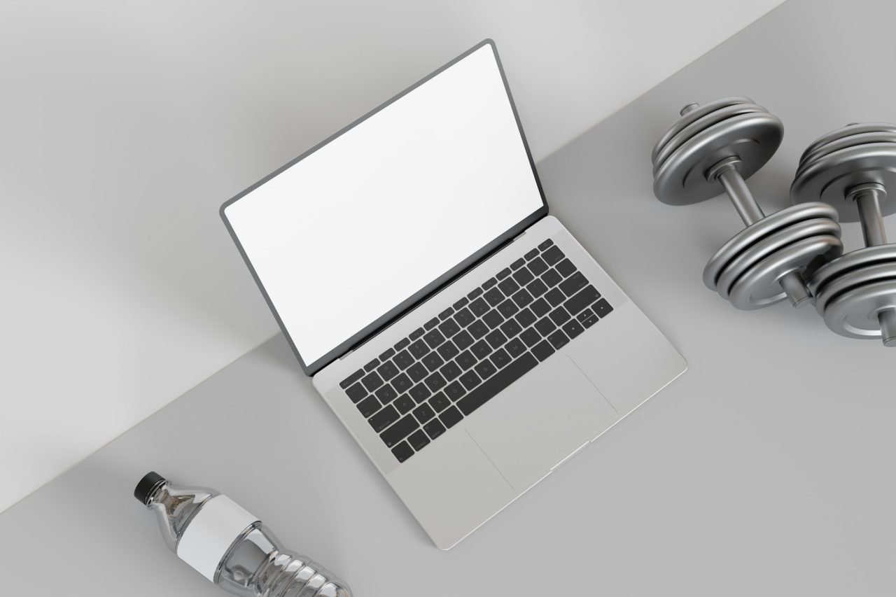 Mockup laptop and dumbbells with water bottle