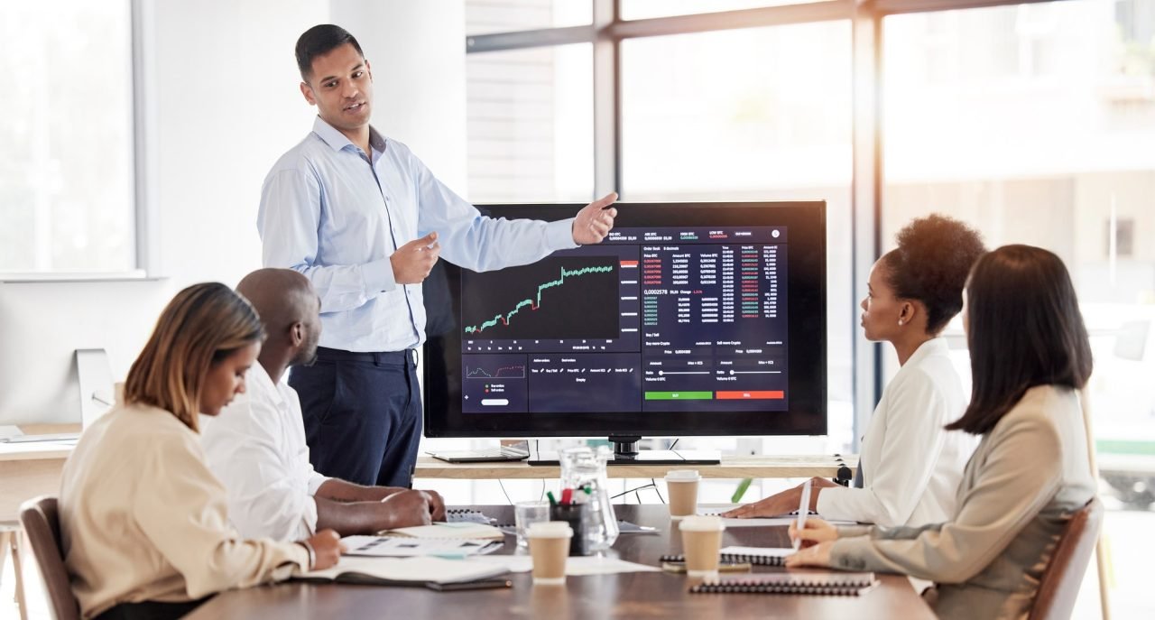 Business people, coach and stock market presentation in meeting for trading, graph and chart monito