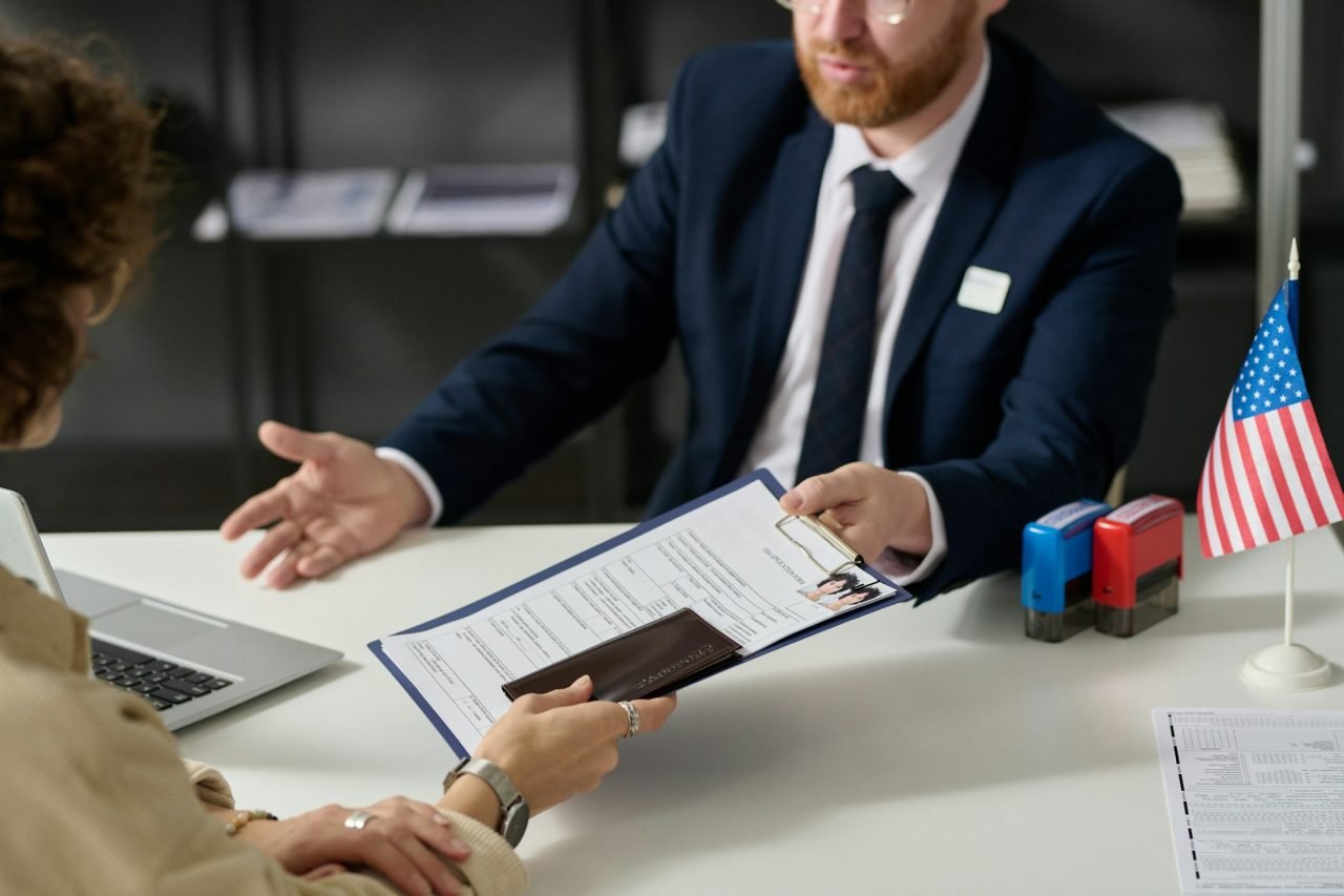 Close up of woman handing visa application